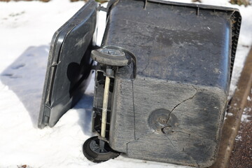 Poster - A black suitcase sits on the snowy ground, ready for travel.