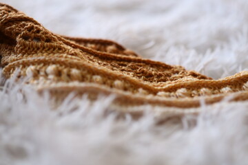 Poster - A close-up shot of a cozy blanket on a bed, suitable for use in travel or home-related contexts.
