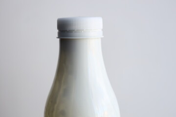 Poster - A simple setup with a bottle of milk placed on a table, ready for use.