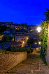 Wall Mural - night view of old cozy street in siena, tuscany, italy, one of the most important of siena. siena is