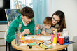 © ces - Young family with their son painting and having fun in the room