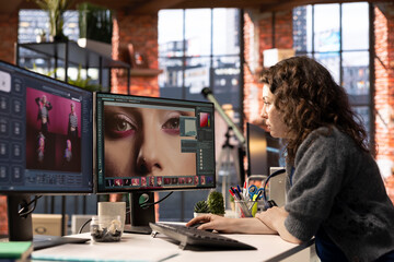 Fototapete - Woman using AI software to turn text prompt into photos and editing the skin, working with retouching interface program for media content. Uses text to image generative models on PC.