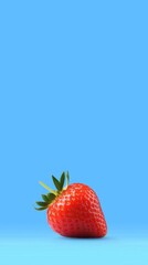 Poster - Single, ripe strawberry rests on a vibrant blue surface, its green leaves adding a touch of contrast to the scene, creating a simple yet visually appealing composition