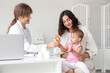 © Pixel-Shot - Woman and cute little baby visiting pediatrician with medicines in clinic