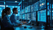 © Vadym - Engineer, system administrator work in telecommunications company datacenter. Man, woman in operation office room, looks at screens with charts, diagrams, code. Cyber security specialists monitor