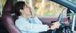 © Jo Panuwat D - woman feeling sleepy and yawn during drive car long time. Asian girl tired and fatigue having headache after driving car in traffic jam. Sleep, stretching and safety concept