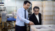 © Thanadon88 - Two men look at a fish tank with a laptop in it. One is wearing a tie.