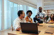 © Jacob Lund - Informal company meeting with diverse staff having a collaborative discussion in a modern office setting