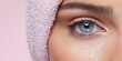 © YURY YUTY - Closeup of a fresh, hydrated eye with a pink towel.