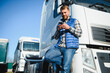 © Serhii - Portrait of young bearded trucker standing by his truck vehicle. Transportation service. Truck driver job