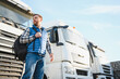 © Serhii - A truck driver with a backpack in a truck parking lot before the start of the work week.