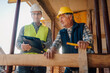 © Ljustina - Construction workers discussing blueprint on building site