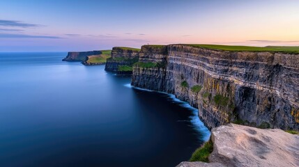 Poster - Seaside cliffs landscapes idea. A breathtaking view of majestic cliffs against a serene ocean at sunset.