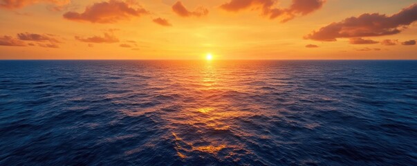 Poster - Sunset over ocean landscapes idea. Stunning sunset over the calm ocean, radiating warm orange and yellow hues.