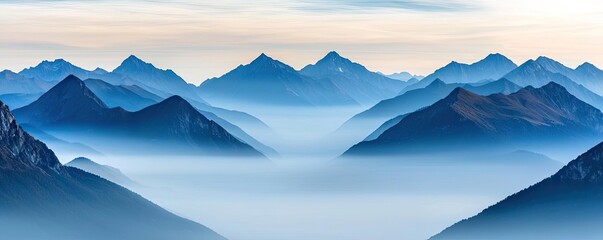 Poster - Misty mountains scenic view landscapes concept. Stunning mountain range with blue tones and mist creating a serene atmosphere.