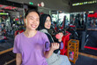 © Leo Lintang - Chinese east asian and arab middle eastern muslim woman working out while lifting a dumbbell at the gym. Fitness exercise and healthy lifestyle concept