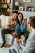 © La Famiglia - Young couple hugging on sofa during therapy session with psychologist
