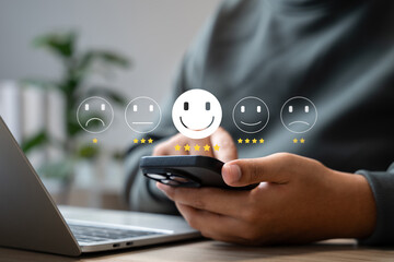 Wall Mural - customer satisfaction survey concept, businessman using smartphone touch happy smiley icon, 5 star s