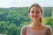 © Supreme - Caucasian Woman in European Forest, displaying vibrant positivity as sunlight filters through the lush trees, creating a beautiful scene.