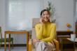 © Crystal - Happy young Asian businesswoman making a business deal using smartphone while working from home office