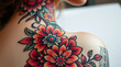 © SvitlanaKvet - A close-up shot reveals a symbolic traditional tattoo art print of a gift for a beloved woman. Vibrant colors depict detailed creative