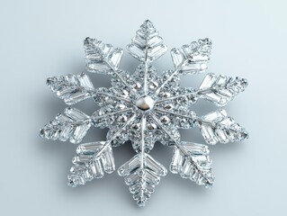 Poster - Elegant silver snowflake ornament on light blue background creating a festive winter season holiday mood with clean studio shot and soft lighting