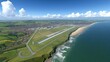 © AGUNG - Coastal airport with runway, rolling hills, and beach.  Panoramic aerial view of modern airfield