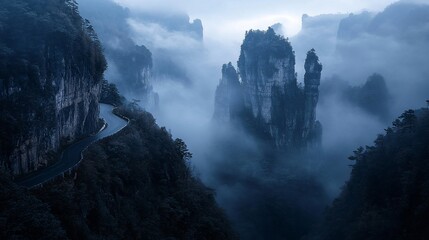 Poster - Misty mountain road winding through dramatic rock formations and clouds at dawn.