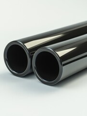 Poster - Sleek Black Metal Pipes on White Surface Reflecting Light in a Modern Studio Setting
