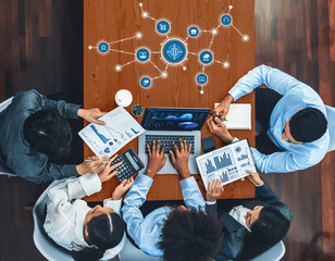 Poster - diverse professionals collaborate around a conference table, analyzing data and strategizing using t