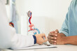 © thatinchan - A young man suffering from erectile dysfunction seeks consultation with a specialist to identify the cause of his erectile dysfunction and seek treatment or cure for the erectile dysfunction.