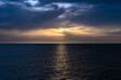 © ADDICTIVE STOCK - Tranquil sea sunset with dramatic clouds and reflections