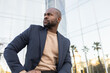 © ADDICTIVE STOCK - Confident business cuban man posing outside a modern building