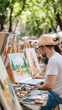 © Sergey - Local artist sketching a vibrant cityscape outdoors under sunlit trees