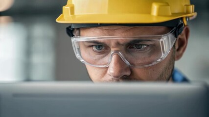 Aufkleber - Engineer wearing a yellow hard hat and safety glasses is focused on working on a computer, the montage of images creating a sense of repetition and diligence