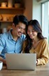 © Artem Zatsepilin - smiling happy young asian couple sitting at wooden table looking at laptop screen, cozy home interior. digital lifestyle. home office, online shopping, social media browsing. sales and discounts