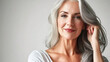 © Aino Minako - A woman with gray hair is smiling and posing for a picture. AI Generated