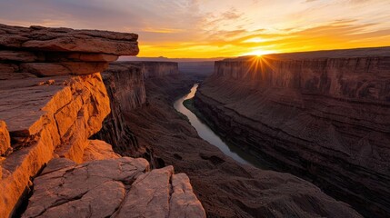Poster - Mountain range landscapes concept. A breathtaking sunset illuminating a vast canyon with a winding river beneath.