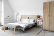 © Pixel-Shot - Interior of light bedroom with bed and tulips and gift box for International Women's Day