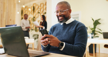 Poster - Phone, creative and business man in office for email, notification or magazine editor typing review. Startup, mobile and happy mature manager online, reading article and check publication on laptop