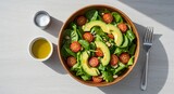 Preparing Fresh Avocado Salad with Spinach and Tomatoes in Wooden Bowl