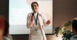 © peopleimages.com - Business woman, seminar and training for speaker in conference room for wellness presentation. Education, forum speech and microphone with corporate coach on stage for public relations or development