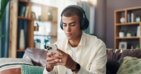 Aufkleber - Man, texting and phone with headphones on sofa for music, sound and streaming subscription in living room. Person, scroll and smartphone with social media, mobile app and chat on couch at apartment
