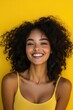 © Ева Поликарпова - A happy woman with a bright smile on a yellow background, perfect for use in promotional materials or social media posts