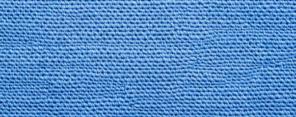 Poster - A close-up view of a textured blue fabric, showcasing intricate weaving patterns and a vibrant hue, Denim Texture woven  seamless.