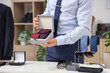 © Pixel-Shot - Man holding box with stylish neckties at counter in boutique