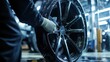 © paukan - Mechanic cleaning alloy wheel in auto shop