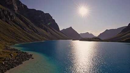 Aufkleber - Majestic mountain lake with clear waters under bright sun, serene nature scene. Tranquility and beauty of remote wilderness.