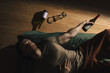 © ivan - A man lies on a bed with empty alcohol bottles next to him