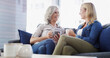 © peopleimages.com - Home, senior mother and daughter with conversation, relax and bonding together in living room. Family, parent and women on couch, discussion or comfort with weekend break, reunion or coffee in lounge
